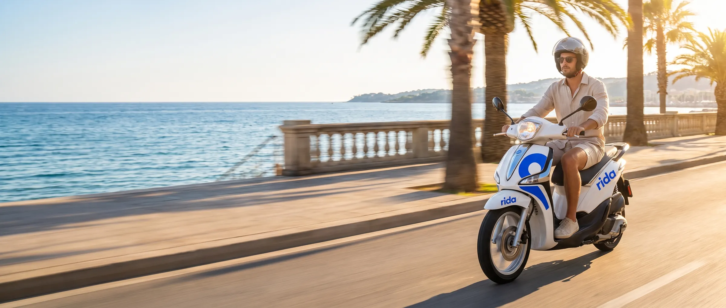 Couple enjoying a rida Vespa by the sea on the Costa del Sol